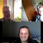 A screenshot of a Zoom meeting with three smiling women
